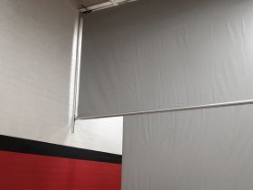 2 MOTOR; WALL GUIDED CENTER-ROLL CURTAIN